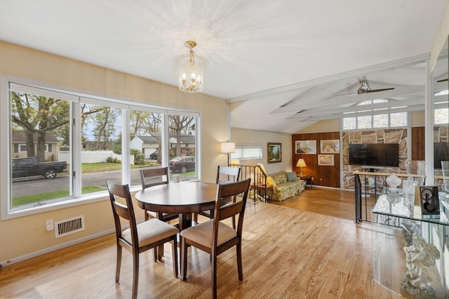 dining space with an inviting chandelier, plenty of natural light, wood finished floors, and visible vents