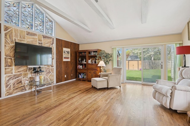 living area with high vaulted ceiling, beamed ceiling, wood walls, and wood finished floors