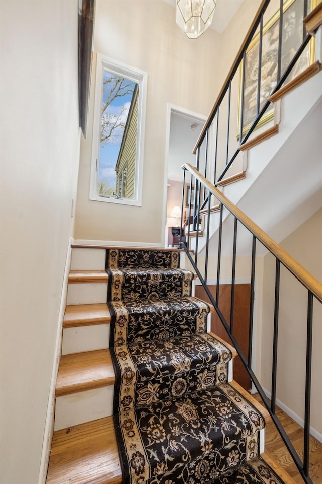 stairs featuring baseboards and wood finished floors