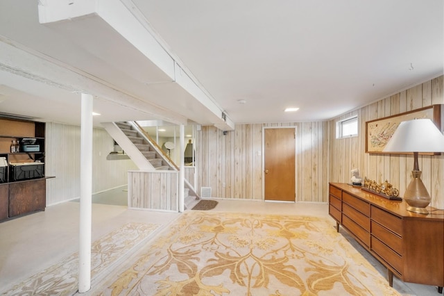 interior space with visible vents, wood walls, and stairs