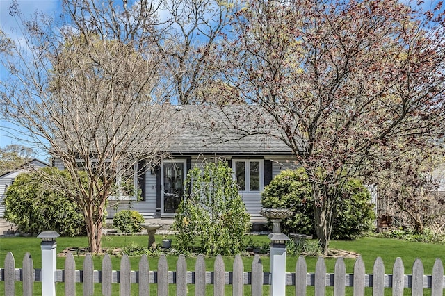 118 Noel Dr, Centereach, NY 11720 - view of front of house featuring a shingled roof, a fenced front yard, and a front lawn