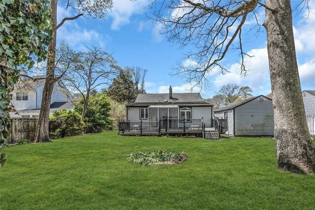 118 Noel Dr, Centereach, NY 11720 - rear view of house featuring a yard, a deck, a shingled roof, and fence