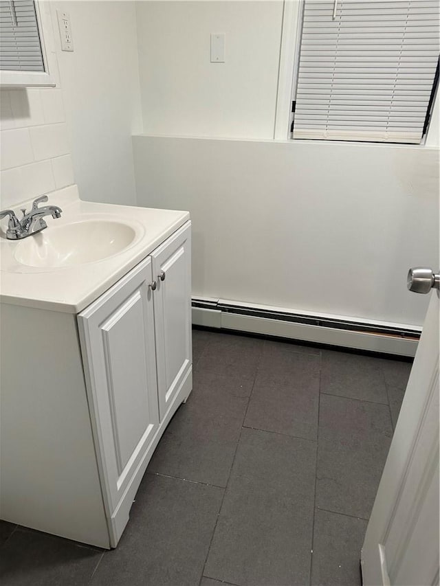 7 Ash St, New Windsor, NY 12553 - bathroom featuring a baseboard heating unit, vanity, tile patterned floors, and backsplash