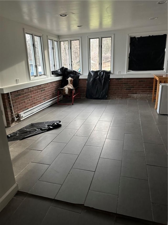 7 Ash St, New Windsor, NY 12553 - sunroom featuring tile patterned flooring, brick wall, and baseboard heating