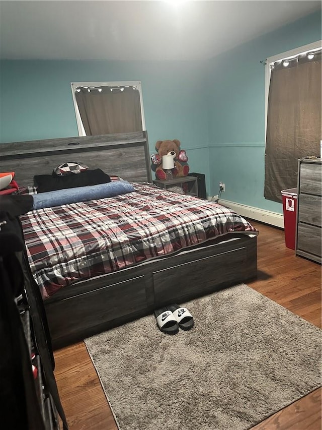 7 Ash St, New Windsor, NY 12553 - bedroom featuring wood finished floors and a baseboard heating unit