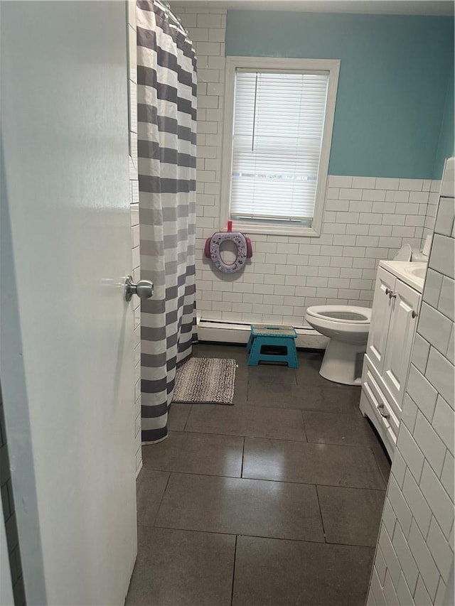 7 Ash St, New Windsor, NY 12553 - bathroom with tile walls, tile patterned flooring, toilet, vanity, and curtained shower