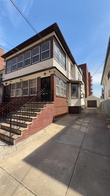 exterior space with fence and brick siding