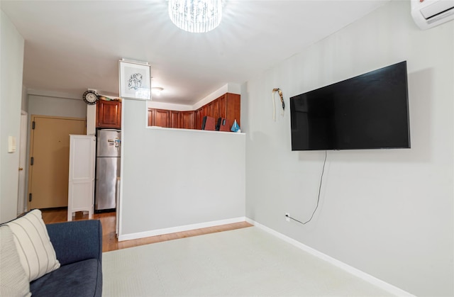 175-26 89th Ave Unit D, Jamaica, NY 11432 - unfurnished room with a wall unit AC, wood finished floors, and a notable chandelier