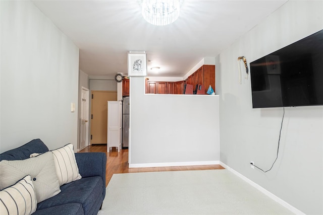 175-26 89th Ave Unit D, Jamaica, NY 11432 - living area with baseboards, a notable chandelier, and light wood-type flooring