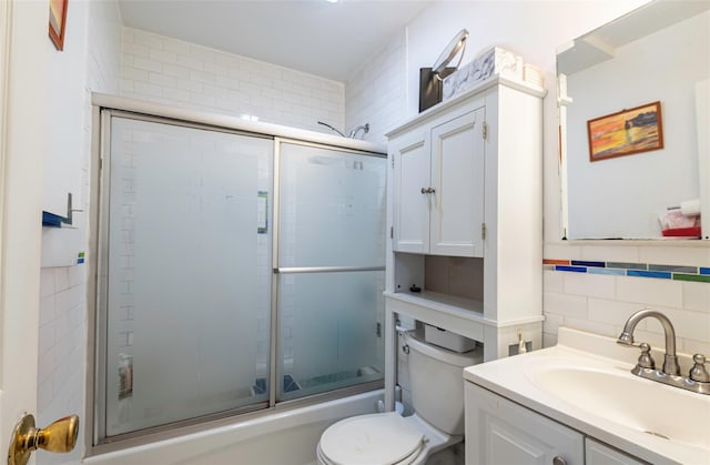 175-26 89th Ave Unit D, Jamaica, NY 11432 - full bathroom with toilet, tile walls, bath / shower combo with glass door, and vanity