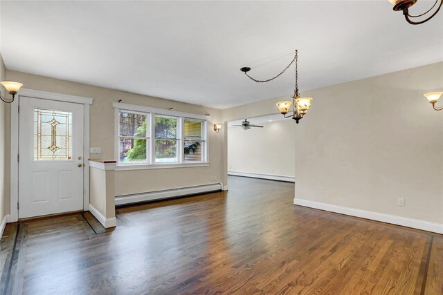 entryway featuring wood finished floors, baseboards, and a baseboard radiator