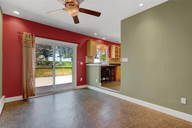 unfurnished living room featuring ceiling fan, baseboards, and recessed lighting
