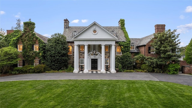 2 Fargo Ln, Irvington, NY 10533 - greek revival house with a front lawn, driveway, and stone siding