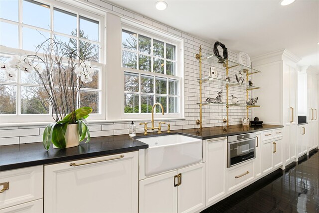 2 Fargo Ln, Irvington, NY 10533 - kitchen with a sink, dark countertops, healthy amount of natural light, decorative backsplash, and recessed lighting