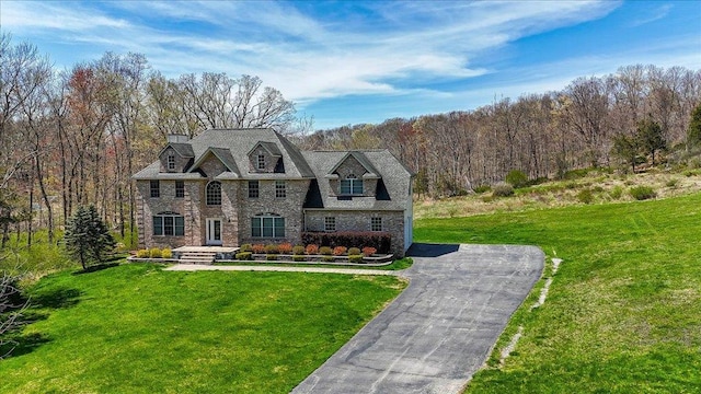 11 Saddle Hill Rd, Chester, NY 10918 - view of front facade featuring stone siding, a view of trees, and a front lawn