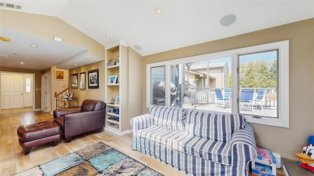 3359 Knight St, Oceanside, NY 11572 - living room with visible vents, built in features, wood finished floors, and vaulted ceiling