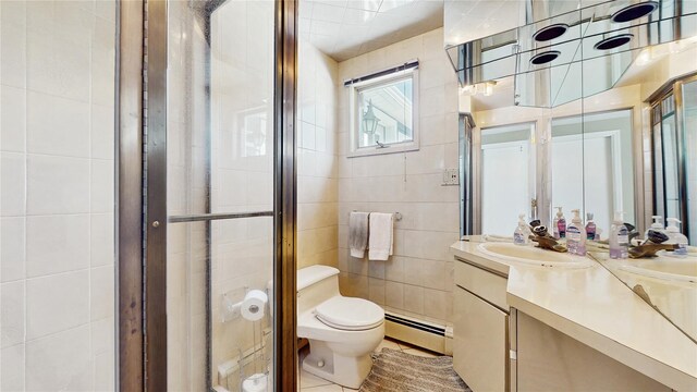 3359 Knight St, Oceanside, NY 11572 - full bath with tile walls, a stall shower, vanity, a baseboard heating unit, and toilet