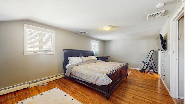 3359 Knight St, Oceanside, NY 11572 - bedroom featuring visible vents, baseboard heating, vaulted ceiling, and wood finished floors