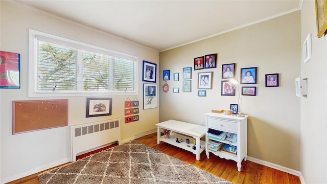 3359 Knight St, Oceanside, NY 11572 - playroom with visible vents, radiator, crown molding, and wood finished floors