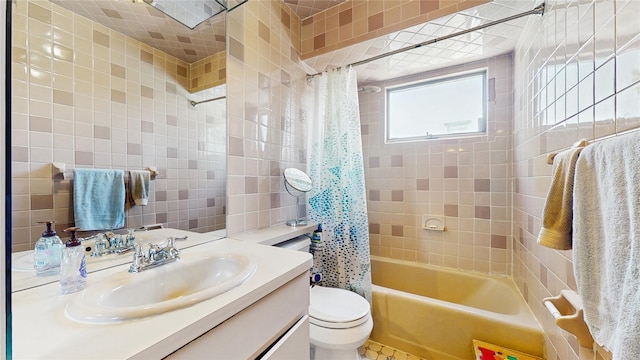 3359 Knight St, Oceanside, NY 11572 - bathroom featuring vanity, shower / tub combo with curtain, toilet, and tile walls
