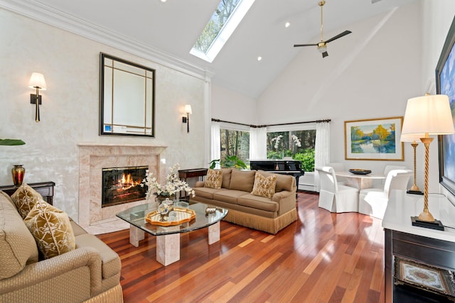 living room featuring recessed lighting, wood finished floors, a high end fireplace, ceiling fan, and high vaulted ceiling