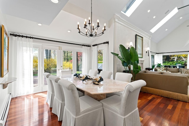 dining space with high vaulted ceiling, a baseboard heating unit, and plenty of natural light