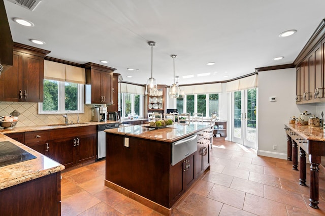 kitchen with a sink, light stone countertops, dishwasher, a warming drawer, and backsplash