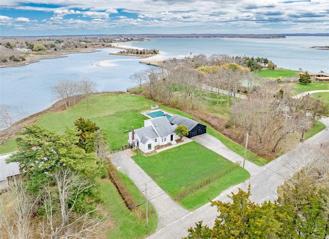 aerial view of property and surrounding area featuring a nearby body of water