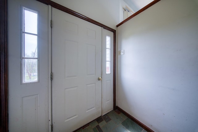 foyer featuring baseboards