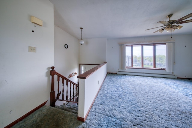 interior space featuring carpet, baseboards, and baseboard heating