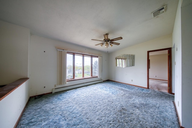 carpeted empty room with ceiling fan, visible vents, baseboard heating, vaulted ceiling, and baseboards