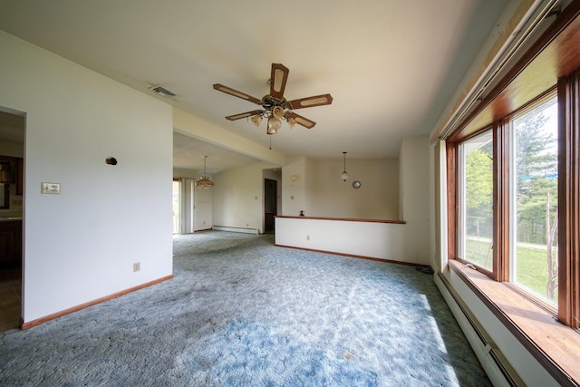 carpeted spare room featuring a ceiling fan, baseboards, a healthy amount of sunlight, and a baseboard radiator
