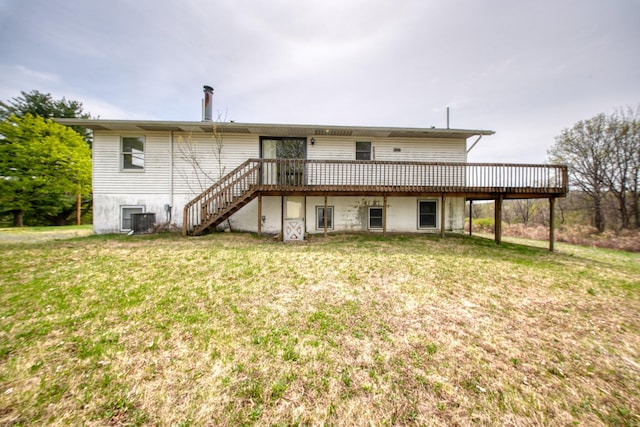 back of property with a wooden deck, a yard, central AC unit, and stairway