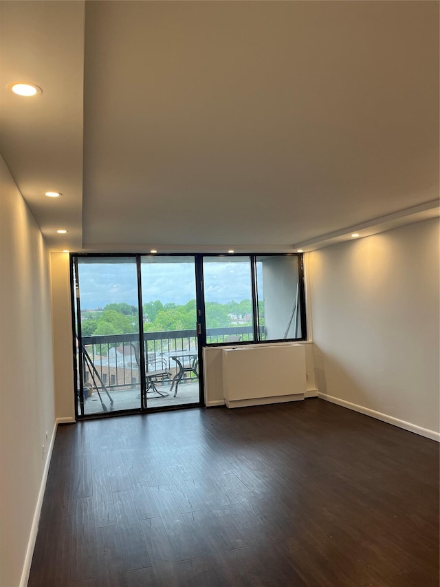 1 Bay Club Dr Unit 9N, Bayside, NY 11360 - empty room featuring dark wood finished floors, baseboards, floor to ceiling windows, and recessed lighting