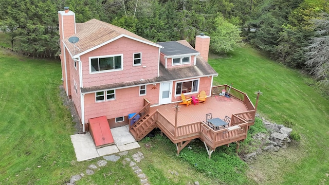 85 Woodard Rd, Parksville, NY 12768 - rear view of house with a chimney, a deck, a yard, a shingled roof, and a view of trees