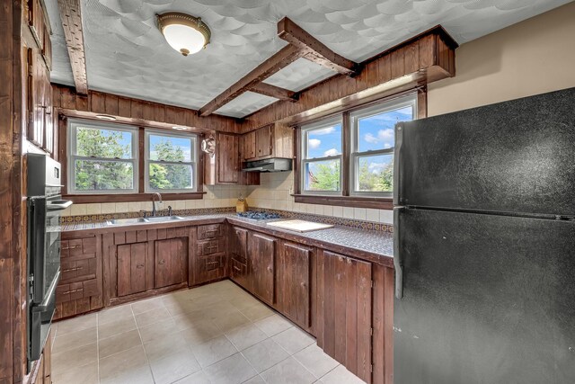 85 Woodard Rd, Parksville, NY 12768 - kitchen featuring freestanding refrigerator, a sink, oven, under cabinet range hood, and light tile patterned floors