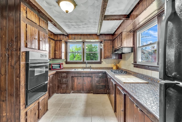 85 Woodard Rd, Parksville, NY 12768 - kitchen with black appliances, a warming drawer, a sink, under cabinet range hood, and beam ceiling