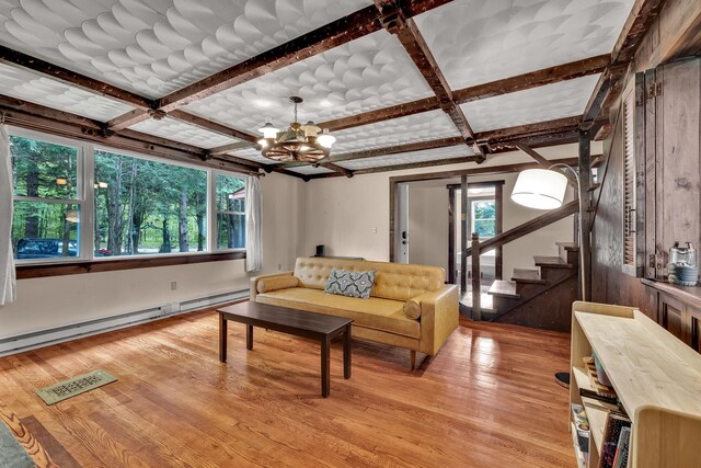 85 Woodard Rd, Parksville, NY 12768 - living area featuring coffered ceiling, a baseboard radiator, light wood-style floors, a chandelier, and stairs