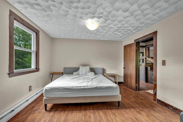 85 Woodard Rd, Parksville, NY 12768 - bedroom featuring a baseboard radiator, baseboards, and wood finished floors