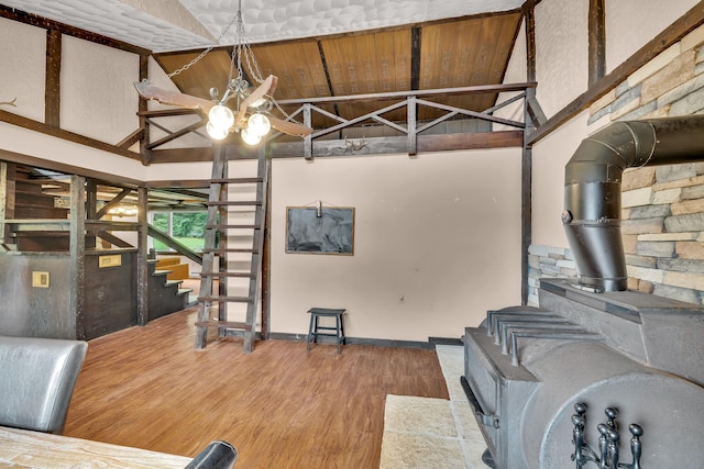 85 Woodard Rd, Parksville, NY 12768 - living room with a wood stove, wood finished floors, high vaulted ceiling, a ceiling fan, and stairway