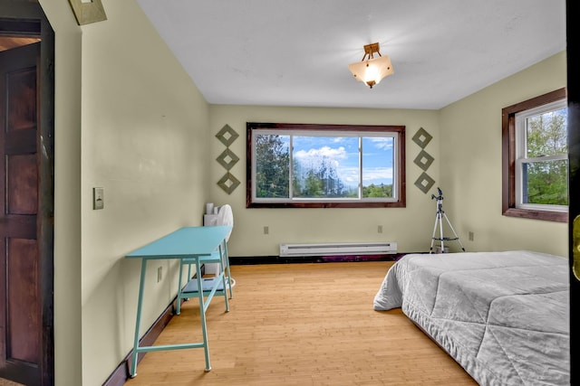 85 Woodard Rd, Parksville, NY 12768 - bedroom with baseboard heating, wood finished floors, and baseboards