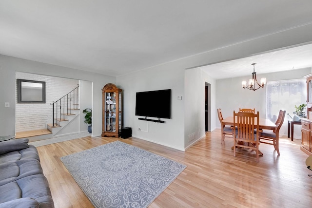 7 Hedge Ln, Centereach, NY 11720 - living room featuring an inviting chandelier, baseboards, light wood-style floors, and stairs