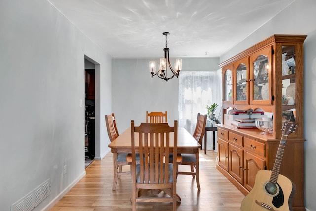 7 Hedge Ln, Centereach, NY 11720 - dining area with visible vents, light wood-style flooring, and an inviting chandelier
