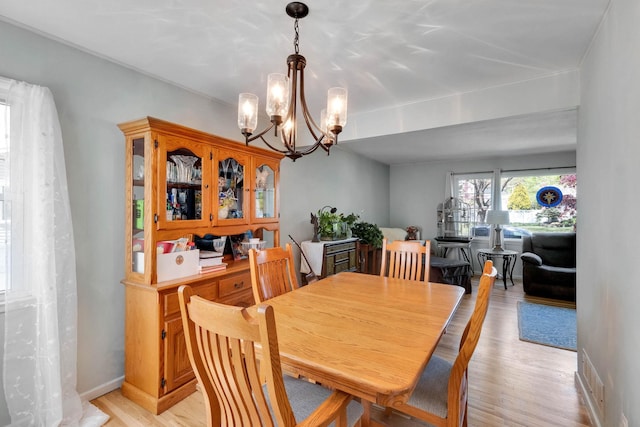 7 Hedge Ln, Centereach, NY 11720 - dining area featuring an inviting chandelier, light wood-type flooring, and visible vents