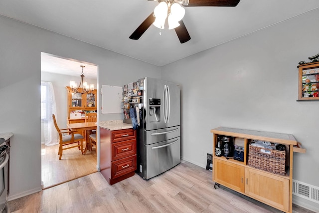 7 Hedge Ln, Centereach, NY 11720 - kitchen with visible vents, light wood-style floors, light countertops, stainless steel fridge with ice dispenser, and ceiling fan with notable chandelier