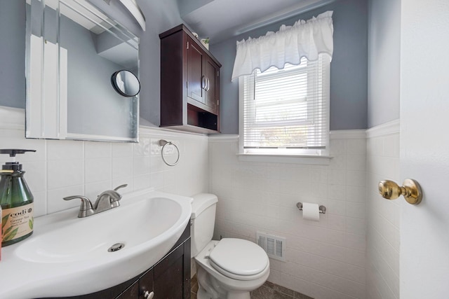 7 Hedge Ln, Centereach, NY 11720 - half bathroom featuring toilet, visible vents, wainscoting, and tile walls