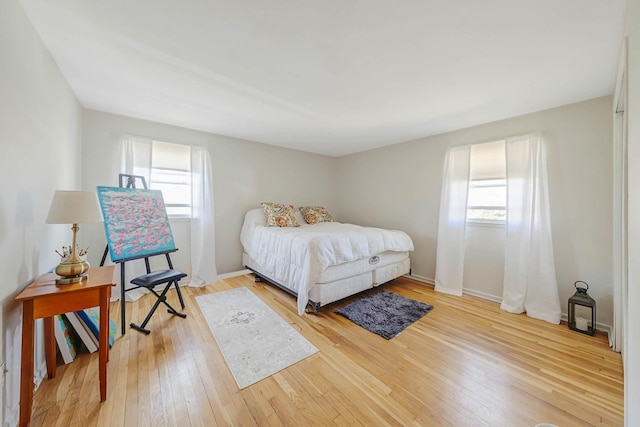 7 Hedge Ln, Centereach, NY 11720 - bedroom featuring light wood-type flooring, baseboards, and multiple windows