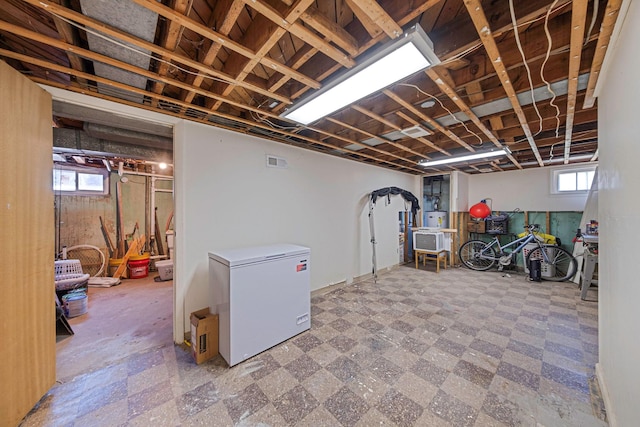 7 Hedge Ln, Centereach, NY 11720 - basement featuring tile patterned floors, fridge, and visible vents