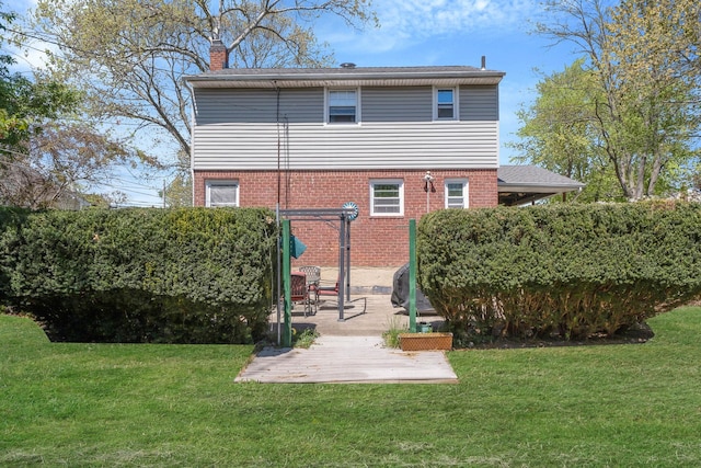 7 Hedge Ln, Centereach, NY 11720 - rear view of property with a lawn, brick siding, a chimney, and a patio area