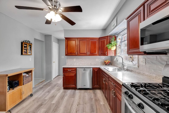 7 Hedge Ln, Centereach, NY 11720 - kitchen featuring decorative backsplash, a ceiling fan, a sink, light countertops, and stainless steel appliances